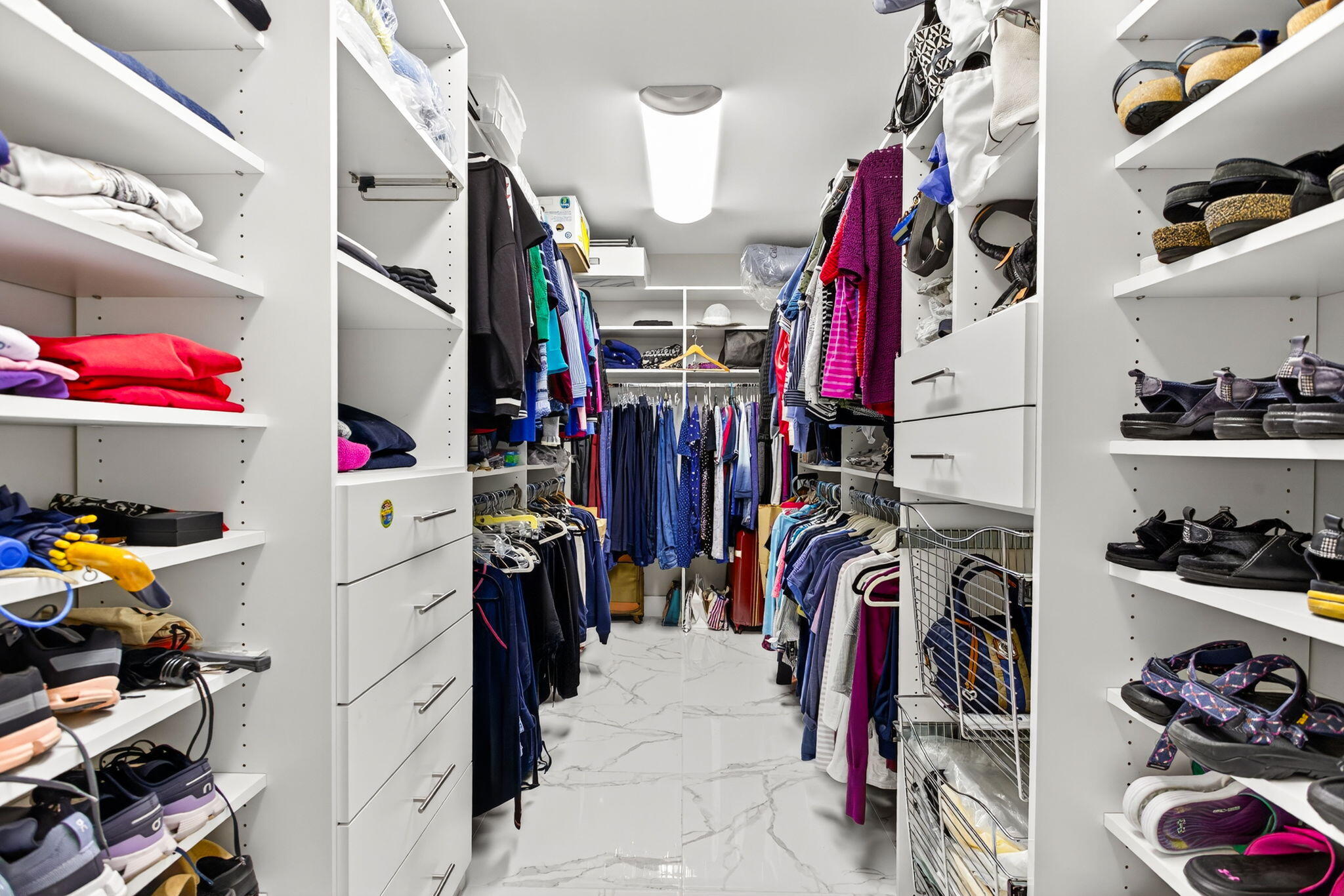 7186 Promenade Drive, Unit 701 Boca Raton, FL 33433 - Photo 26 of 39 a view of walk in closet with clothes and shoes