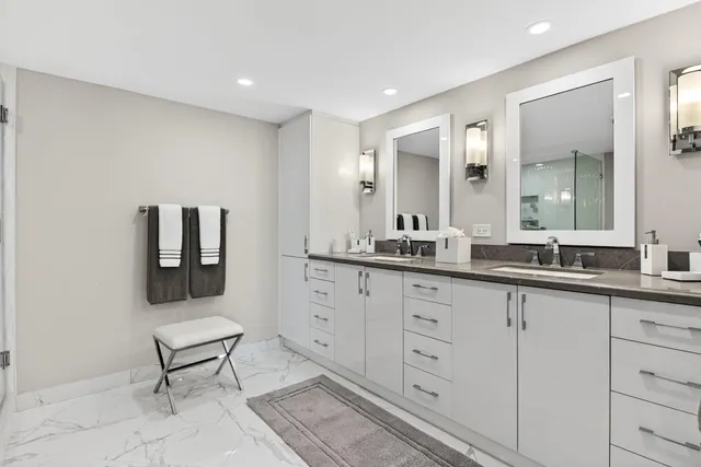 a spacious bathroom with a double vanity sink and a mirror