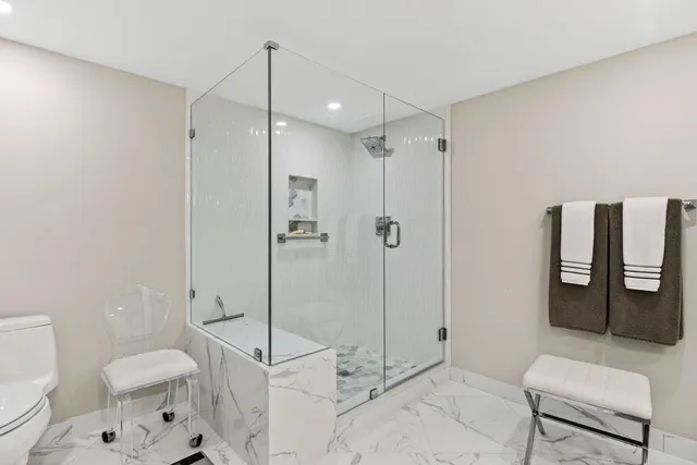 a bathroom with a toilet sink and shower