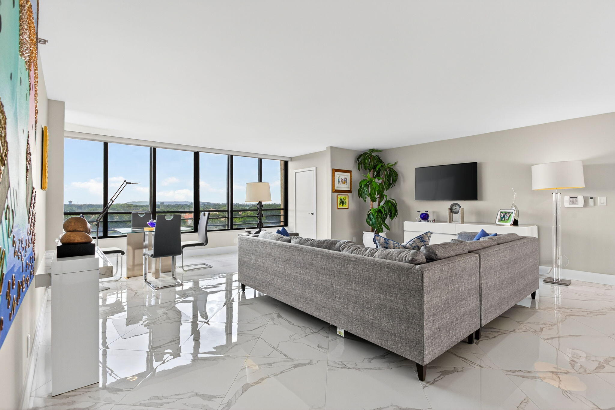 7186 Promenade Drive, Unit 701 Boca Raton, FL 33433 - Photo 3 of 39 a living room with furniture large windows and flat screen tv