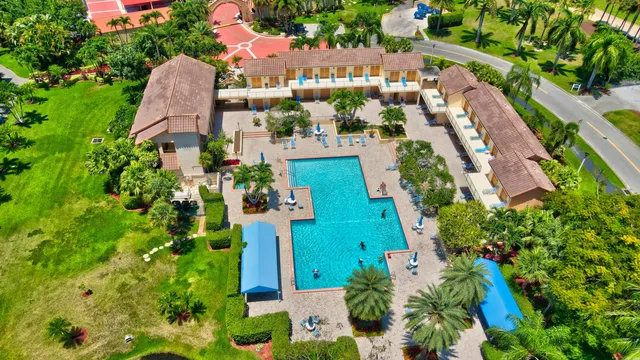 an aerial view of a residential houses with outdoor space and street view