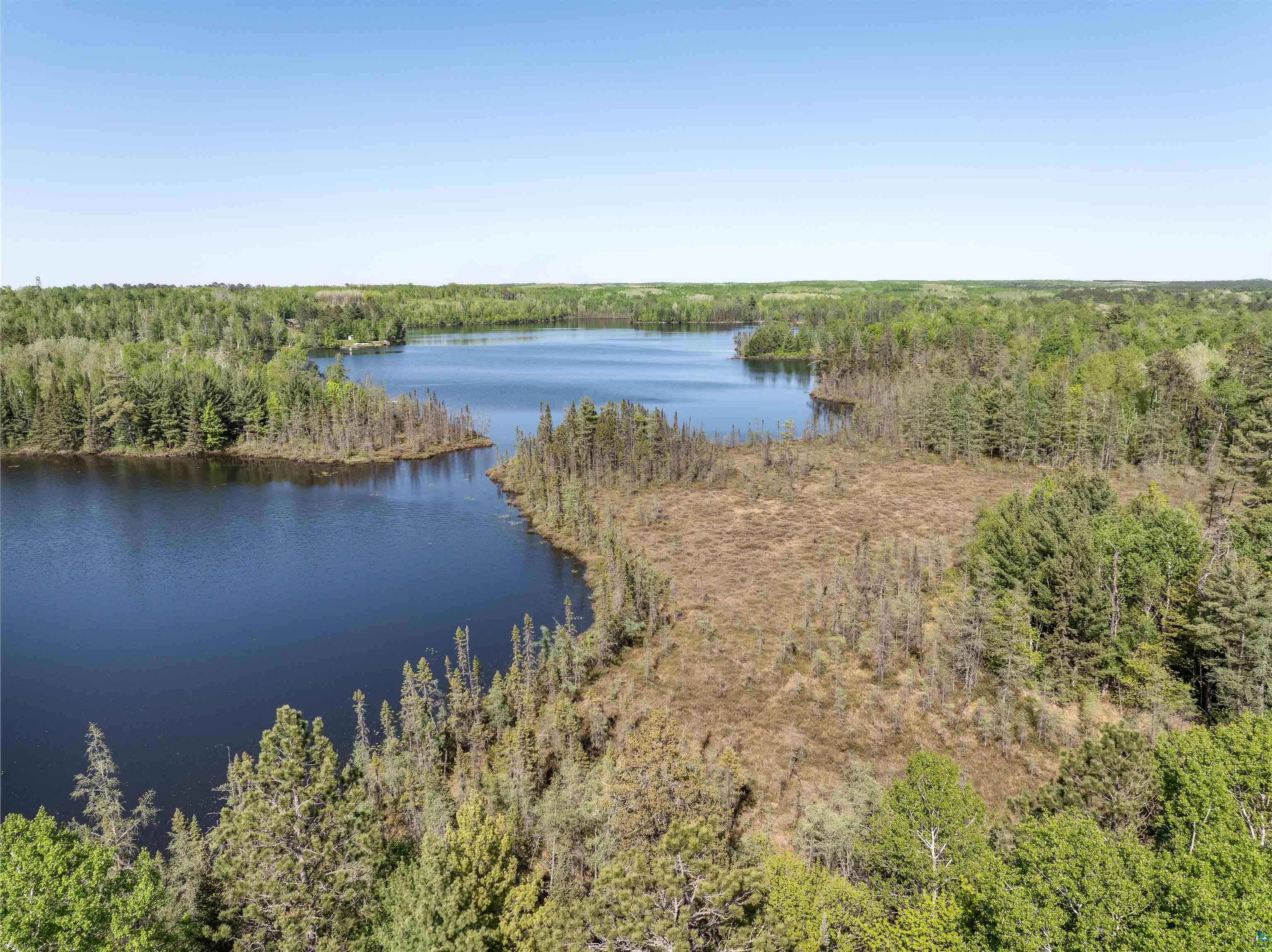 9064 Peppard Road Britt, MN 55710 - Photo 11 of 40 Expansive natural landscape featuring a prominent body of water, extensive tree coverage, and varied terrain