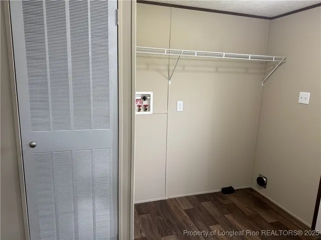 a view of storage and utility room with racks on the wall