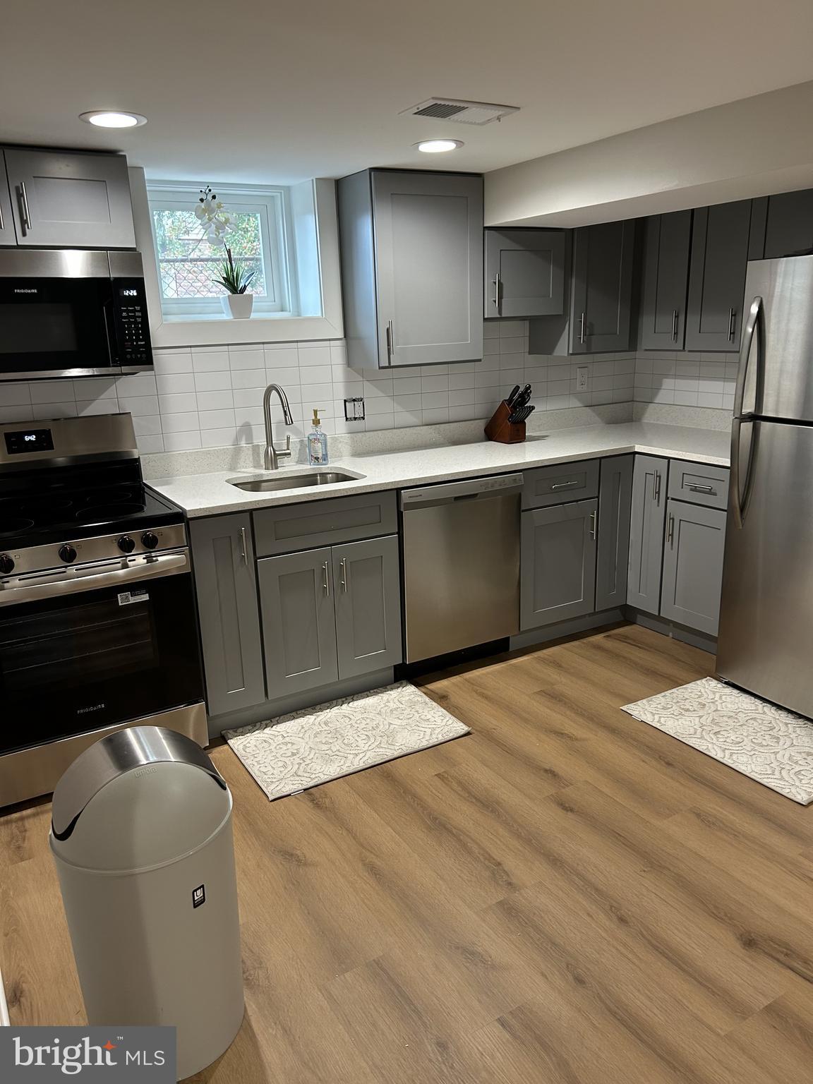 1516 Hamilton Street Northwest Washington, DC 20011 - Photo 2 of 14 a kitchen with a sink a stove and cabinets