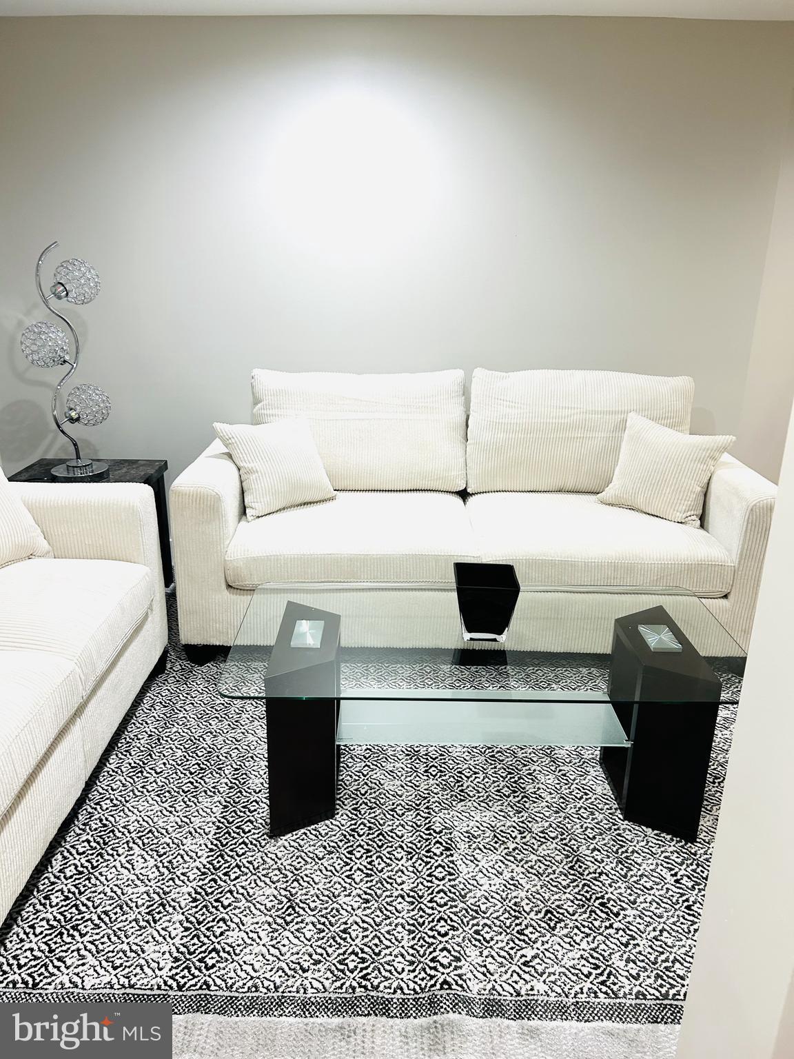 1516 Hamilton Street Northwest Washington, DC 20011 - Photo 6 of 14 a living room with a couch and a coffee table