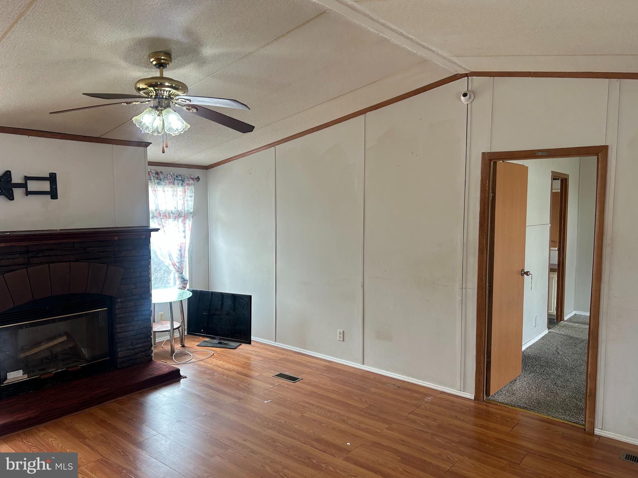 47 Evidence Road, Unit 231 Magnolia, DE 19962 - Photo 3 of 19 a view of a livingroom with a fireplace a ceiling fan and wooden floor