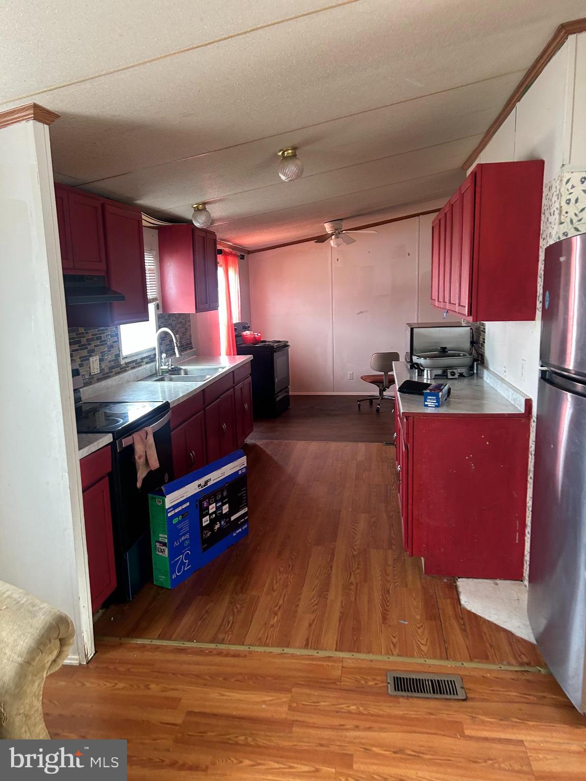 47 Evidence Road, Unit 231 Magnolia, DE 19962 - Photo 6 of 19 a kitchen with stainless steel appliances granite countertop a stove a refrigerator a sink dishwasher with chairs and wooden floor