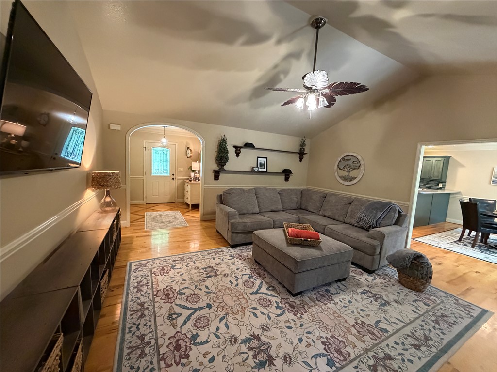 232 Hunters Trail Walhalla, SC 29691 - Photo 8 of 38 This inviting living space features warm wood flooring and a soaring vaulted ceiling.