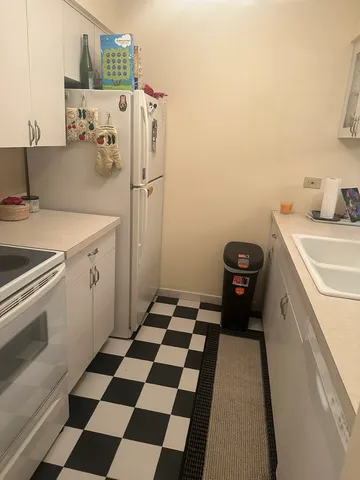 a kitchen with a refrigerator and a sink