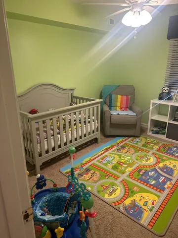 a bedroom with furniture and a rug