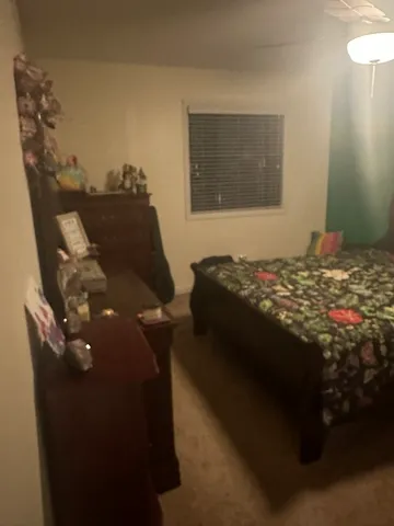 a bed sitting in a bedroom next to a window