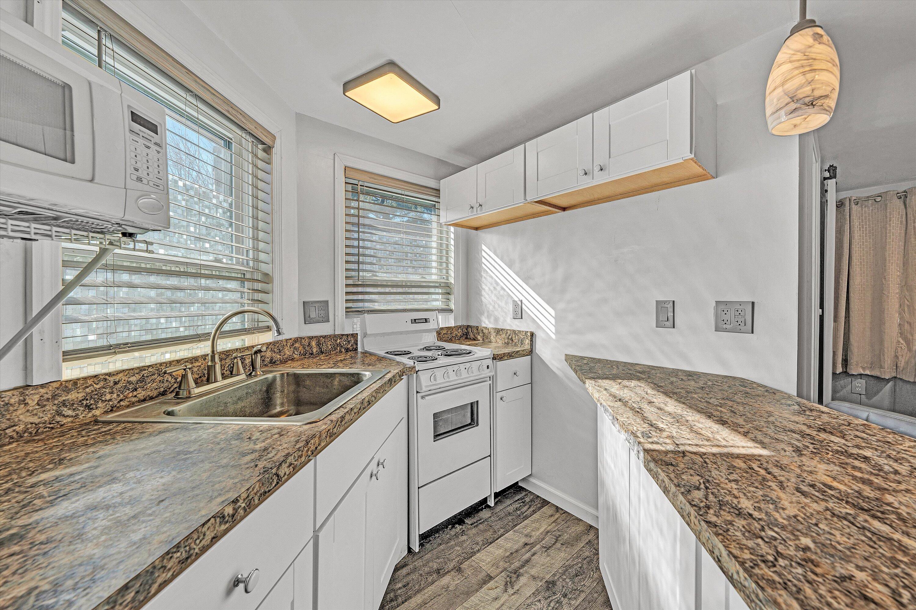 1944 Blue Ridge Springs Road Blue Ridge, VA 24064 - Photo 46 of 60 a kitchen with a stove sink and cabinets