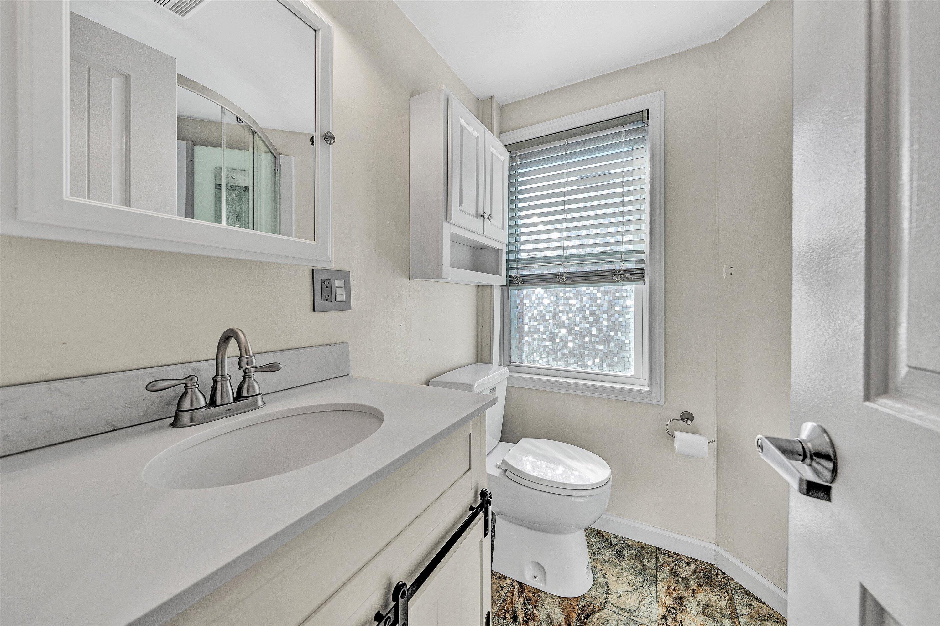 1944 Blue Ridge Springs Road Blue Ridge, VA 24064 - Photo 47 of 60 a bathroom with a sink a toilet and a mirror