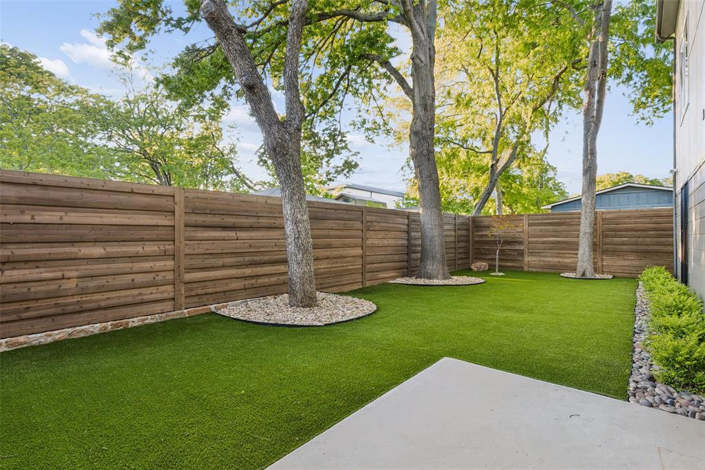 4311 Merrell Road Dallas, TX 75229 - Photo 14 of 30 a view of a backyard with lawn chairs plants and large tree