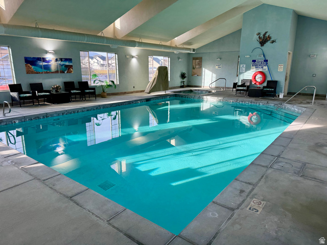 1204 South 1150th Street West Payson, UT 84651 - Photo 25 of 26 Clubhouse Indoor swimming pool featuring a built-in spa, sloped ceiling with skylights, multiple windows, and concrete decking