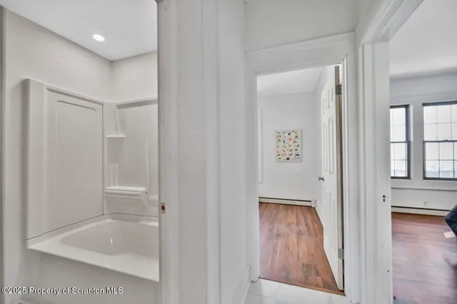 a bathroom with a bathtub and shower