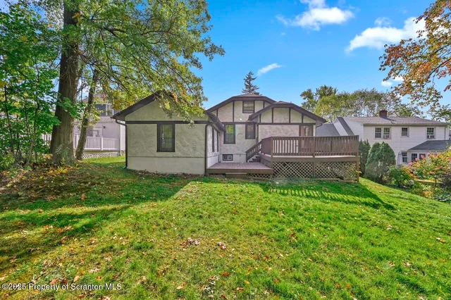 a view of backyard with a deck and wooden floor