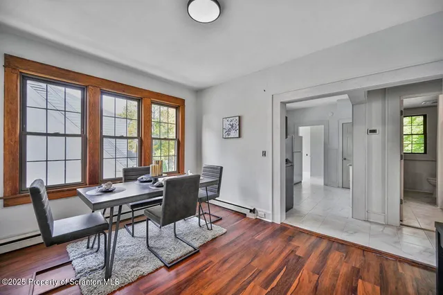 a dining room with furniture and wooden floor