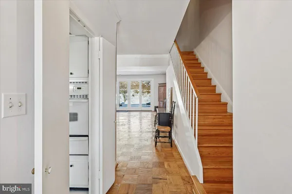a view of entryway with furniture and wooden floor