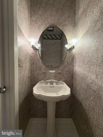 a bathroom with a sink and mirror