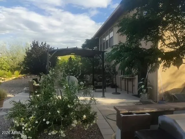 a view of backyard with outdoor seating and green space