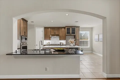 a bedroom with a large bed and a chandelier
