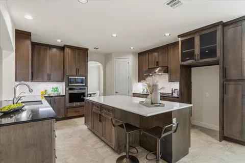 a spacious bathroom with a granite countertop sink and a mirror