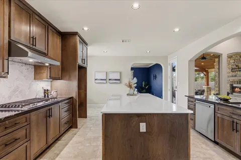 a bathroom with a granite countertop sink a toilet and shower