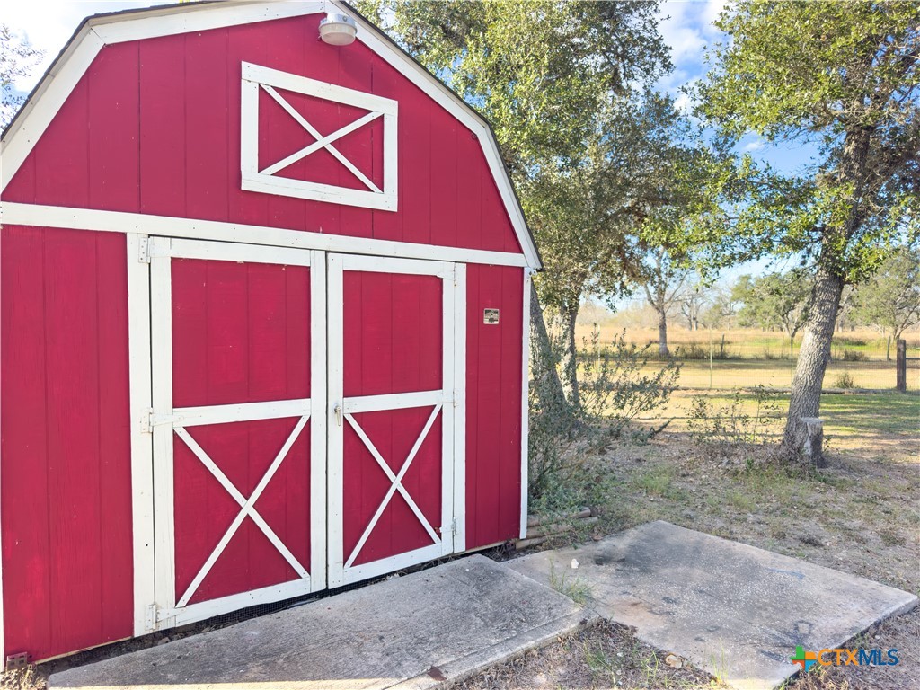 1374 Bego Road Goliad, TX 77963 - Photo 33 of 44 This "Red Barn" has electricty and shelving to keep you organized!