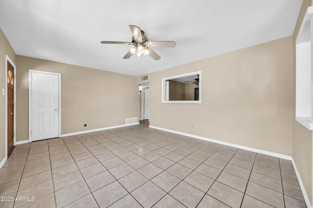 a view of a kitchen with furniture and an empty room