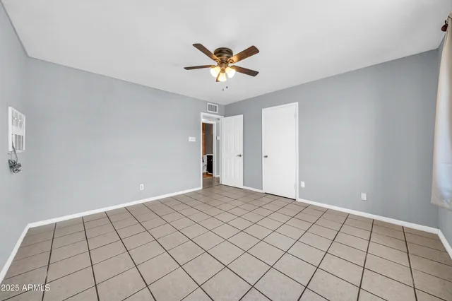 a view of an empty room and a bathroom