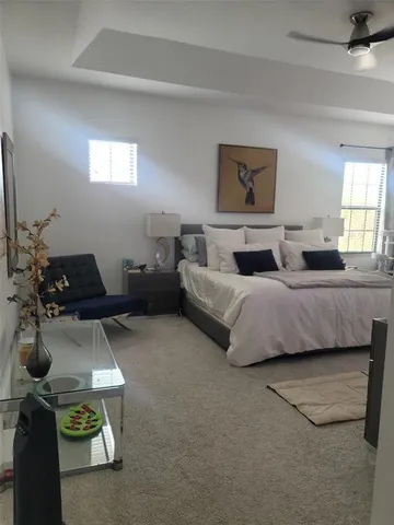 a bedroom with bed and window