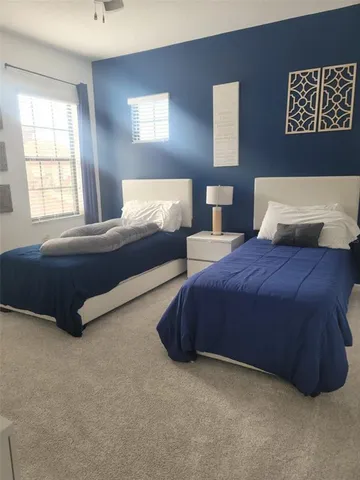 a spacious bedroom with a bed and window