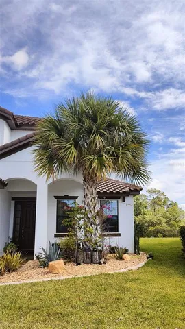 a view of a house with a swimming pool and sitting area