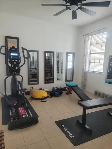 a room with gym equipment and a large window