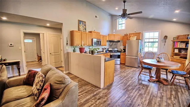 a living room with furniture and a wooden floor