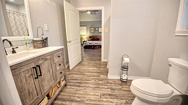 a bathroom with a sink a toilet and a mirror