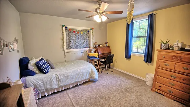 a bedroom with furniture and a window