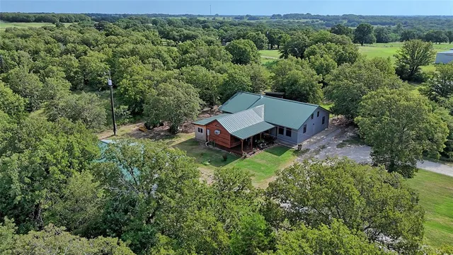 an aerial view of a house with a yard