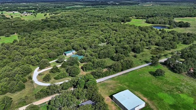 an aerial view of a house with a yard