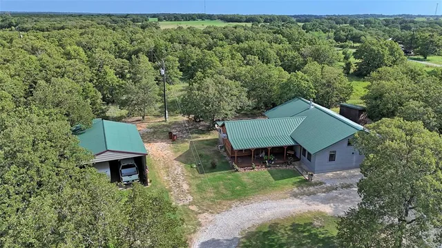 an aerial view of a house with a yard