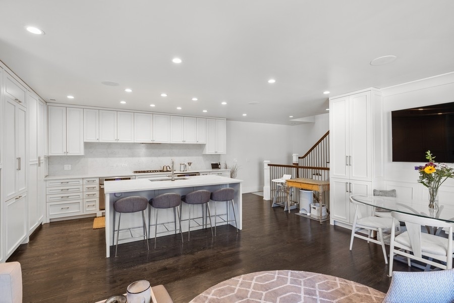 1226 West Draper Street Chicago, IL 60614 - Photo 8 of 28 a kitchen with a dining table chairs and white appliances