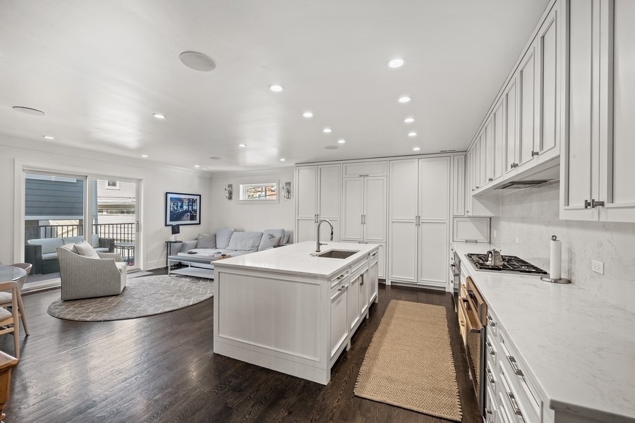 1226 West Draper Street Chicago, IL 60614 - Photo 10 of 28 a open kitchen with stainless steel appliances granite countertop a lot of counter space and wooden floors