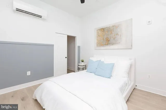 a bedroom with a bed and wall painting