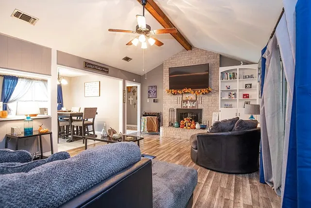 a living room with furniture and a fireplace