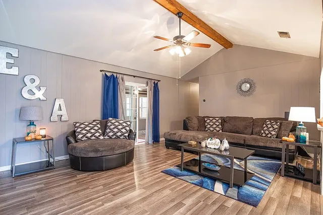 a living room with furniture and wooden floor