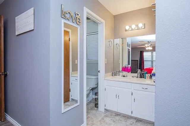 a bathroom with a sink vanity and a mirror