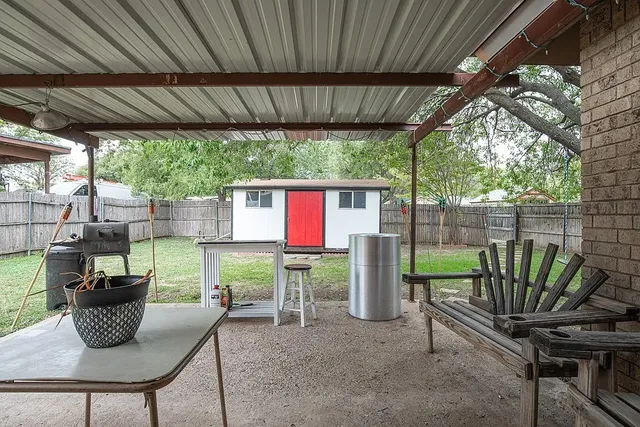 a view of a porch with furniture and a yard