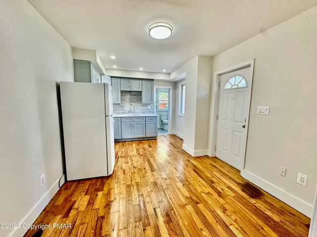 a view of kitchen with cabinets and wooden floor