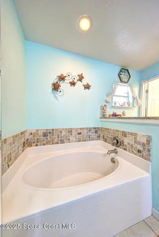 a bathroom with a tub and a sink